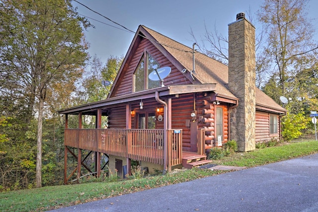 2539 Fleming Way, Sevierville, TN 37876 - cabin featuring a porch, log exterior, a chimney, and a shingled roof