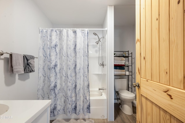 bathroom featuring vanity, wood finished floors, shower / bath combination with curtain, and toilet