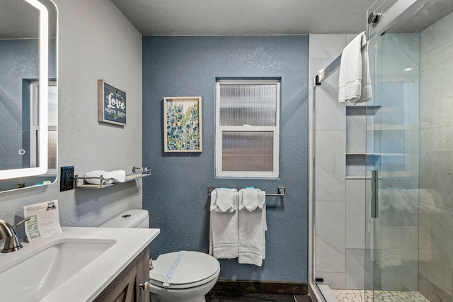 bathroom featuring vanity, toilet, and walk in shower