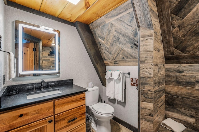 bathroom with vanity, toilet, and a shower