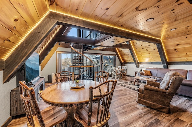 dining space featuring lofted ceiling with beams, wood-type flooring, and wooden ceiling