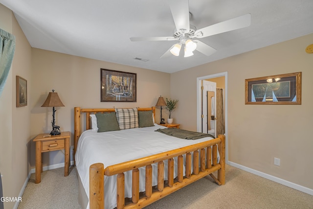 bedroom with light colored carpet, baseboards, ceiling fan, and connected bathroom