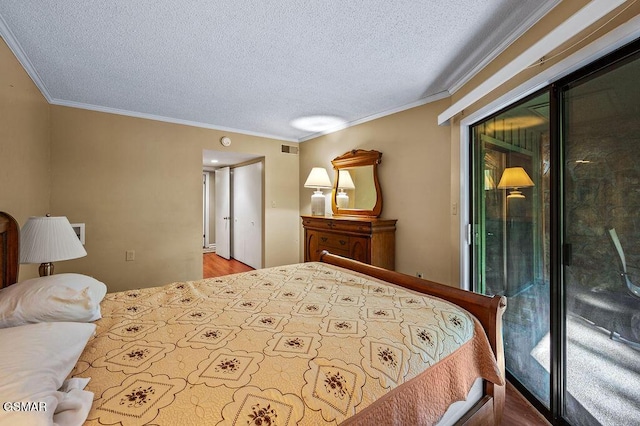 bedroom with a textured ceiling, access to exterior, ornamental molding, and wood-type flooring