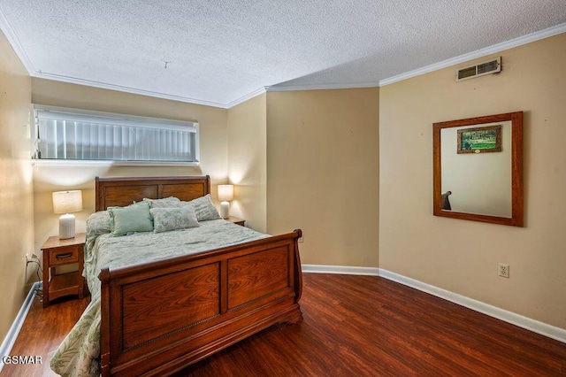 bedroom featuring dark hardwood / wood-style flooring, crown molding, and a textured ceiling