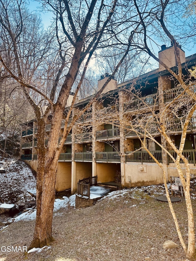 view of snow covered rear of property