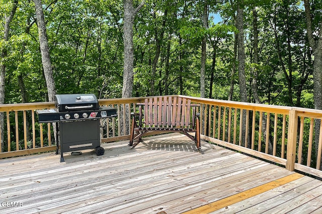 wooden deck featuring a grill