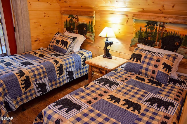 bedroom featuring wooden walls and wood finished floors