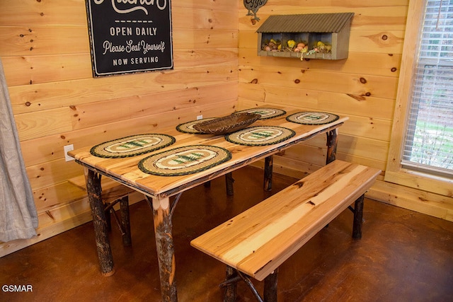 dining space with wood walls