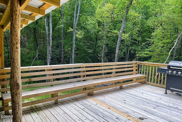 deck with a forest view and a grill