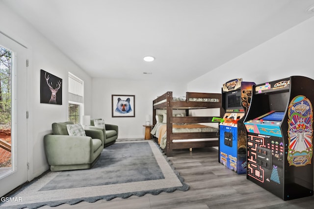 bedroom featuring wood finished floors and visible vents
