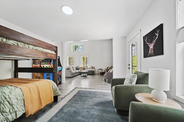 bedroom featuring access to outside and wood finished floors