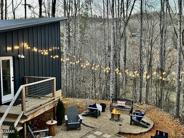view of yard with an outdoor fire pit and a deck
