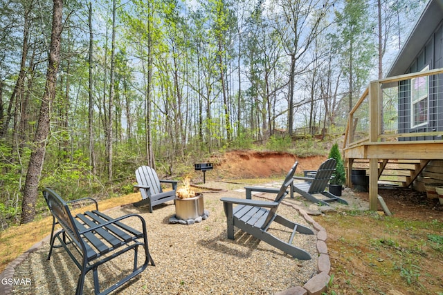 view of yard with an outdoor fire pit and a deck