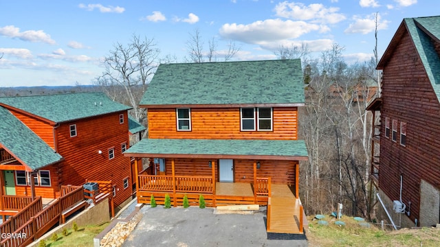 view of front of house with covered porch and a shingled roof