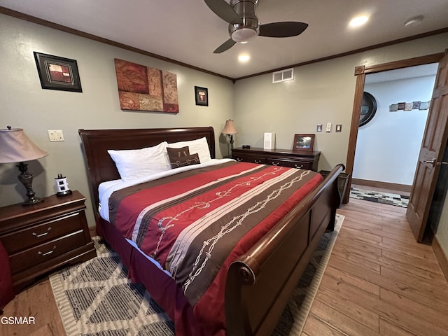 bedroom featuring crown molding, ceiling fan, and light wood-type flooring