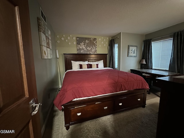 carpeted bedroom with a textured ceiling