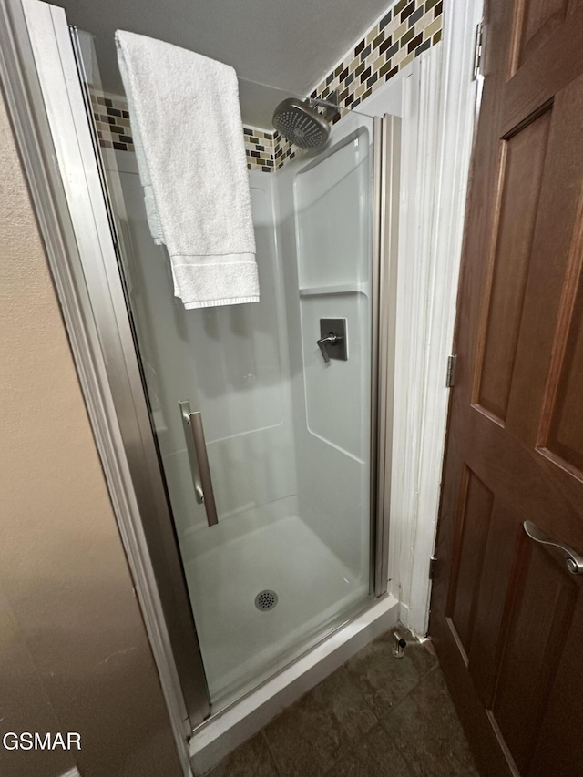 bathroom featuring tile patterned flooring and a shower with shower door