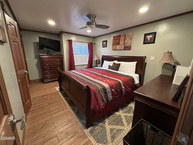 bedroom with ornamental molding, ceiling fan, and light hardwood / wood-style flooring