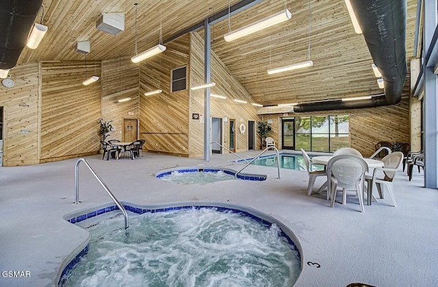 view of pool with an indoor hot tub