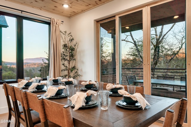 dining area featuring recessed lighting, a mountain view, and wood ceiling