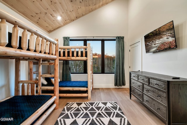 bedroom with light wood finished floors, high vaulted ceiling, recessed lighting, baseboards, and wood ceiling