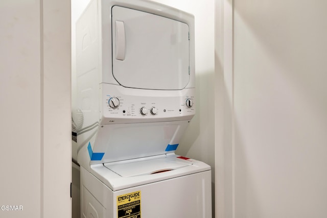 clothes washing area with laundry area and stacked washer and clothes dryer