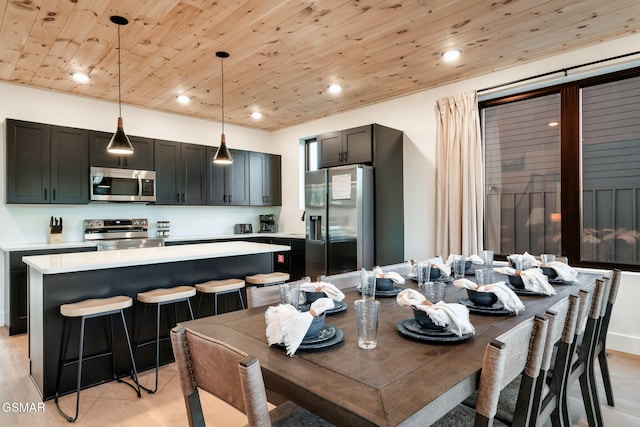 dining room featuring recessed lighting, wood ceiling, and light wood finished floors
