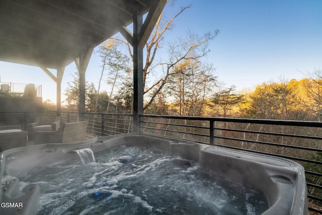 wooden terrace featuring a hot tub