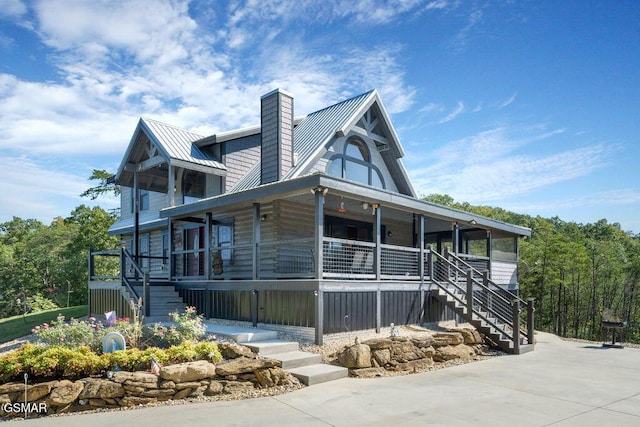 view of side of property featuring covered porch