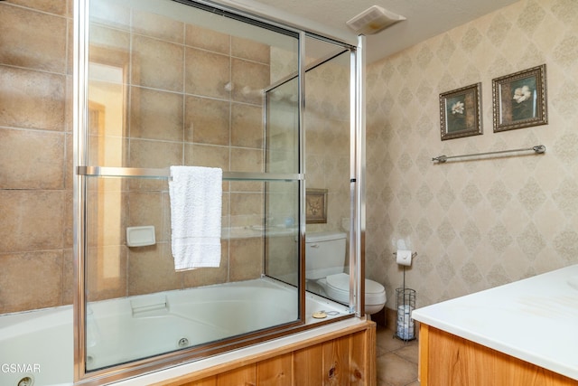 bathroom featuring shower / bath combination with glass door, tile patterned flooring, and toilet