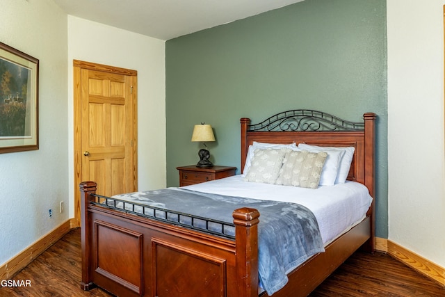 bedroom with dark hardwood / wood-style floors