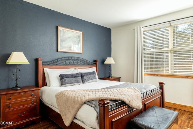 bedroom with dark wood-type flooring