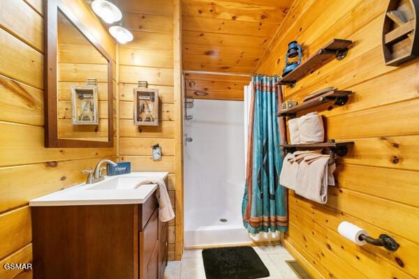 bathroom featuring wooden walls, vanity, wood ceiling, tile patterned floors, and a shower with curtain