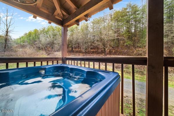 wooden deck with a hot tub