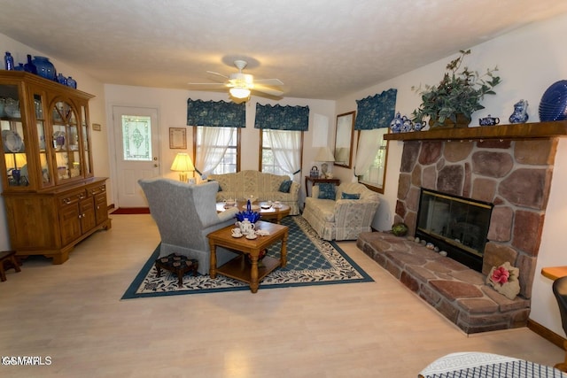 3188 Wears Dr, Sevierville, TN 37862 - living area featuring ceiling fan, a stone fireplace, and light wood-style floors