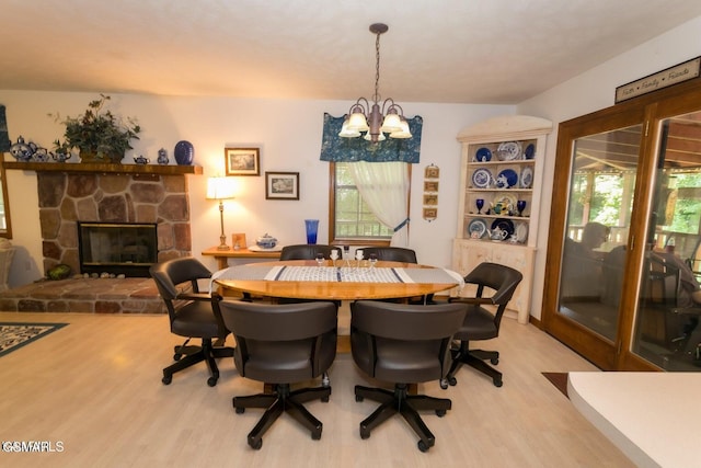 3188 Wears Dr, Sevierville, TN 37862 - dining space with a stone fireplace, light wood finished floors, plenty of natural light, and a chandelier