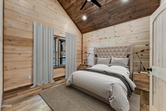 bedroom featuring hardwood / wood-style flooring, lofted ceiling, ceiling fan, and wood ceiling