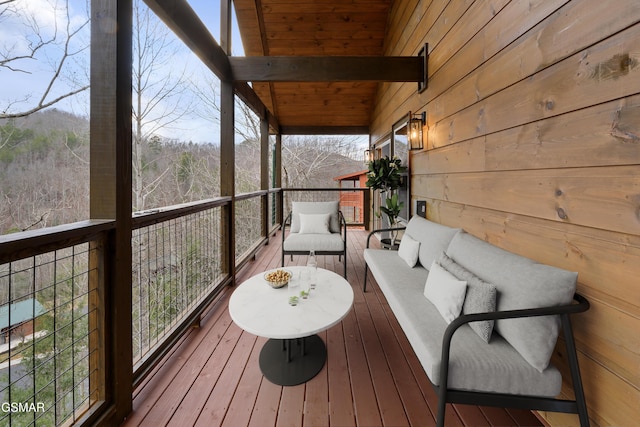 wooden terrace featuring an outdoor hangout area