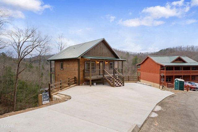 rear view of house featuring a porch