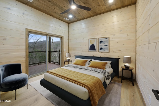 bedroom featuring access to exterior, ceiling fan, light hardwood / wood-style flooring, wood walls, and wood ceiling