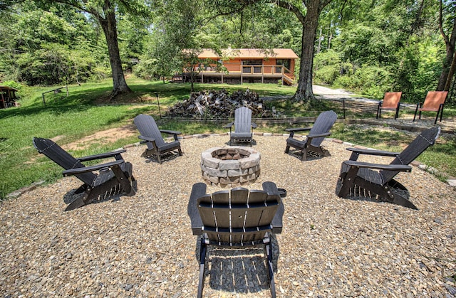 view of yard featuring a fire pit and a deck