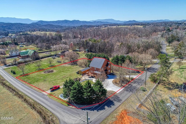 bird's eye view featuring a mountain view and a wooded view