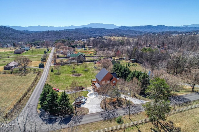 birds eye view of property with a mountain view, a rural view, and a wooded view