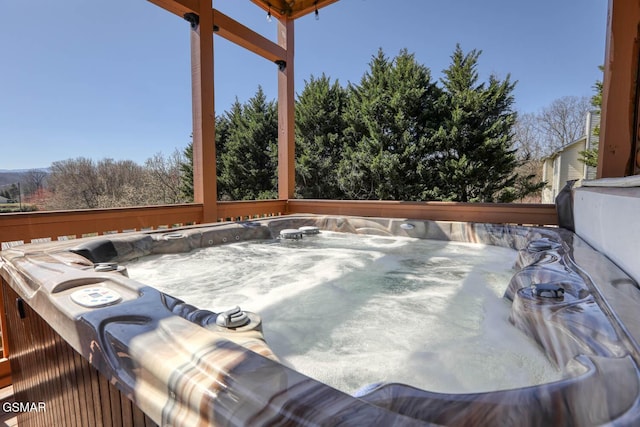 view of patio featuring a wooden deck and a hot tub