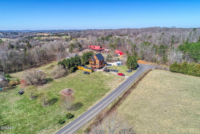 drone / aerial view featuring a forest view