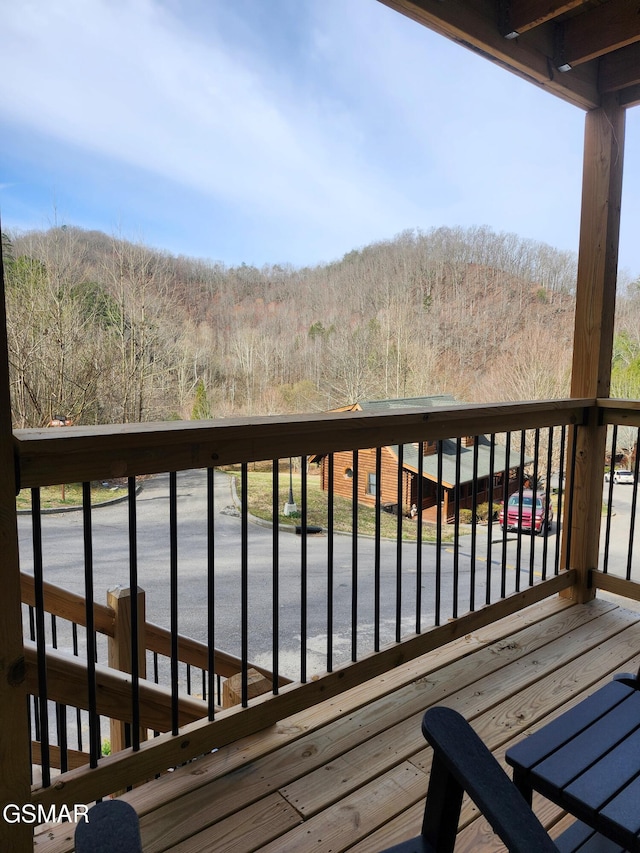 wooden deck with a forest view