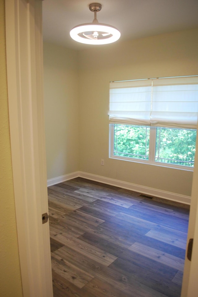 unfurnished room featuring dark hardwood / wood-style flooring