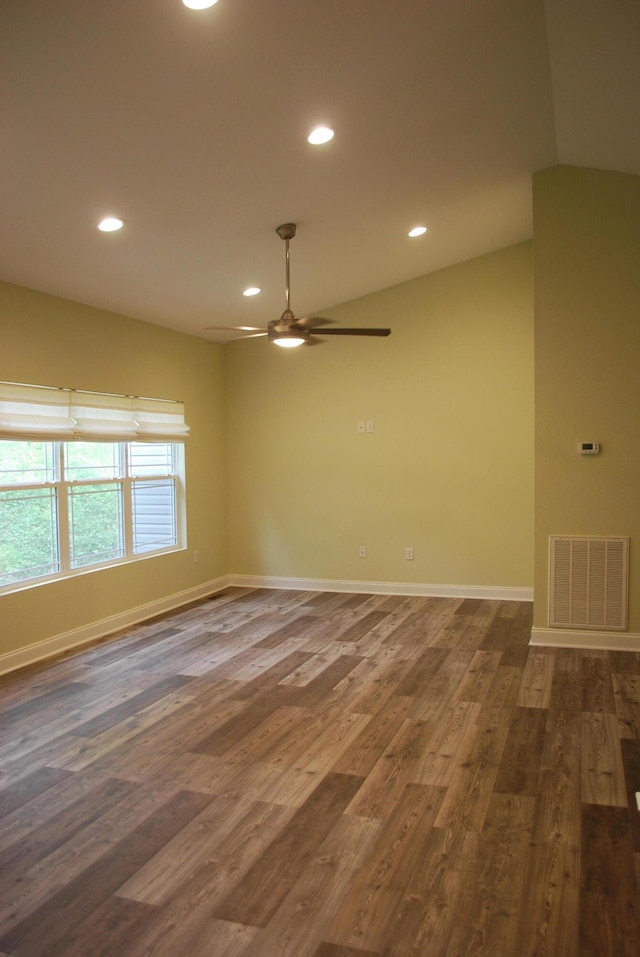 unfurnished room featuring ceiling fan, dark hardwood / wood-style flooring, and lofted ceiling