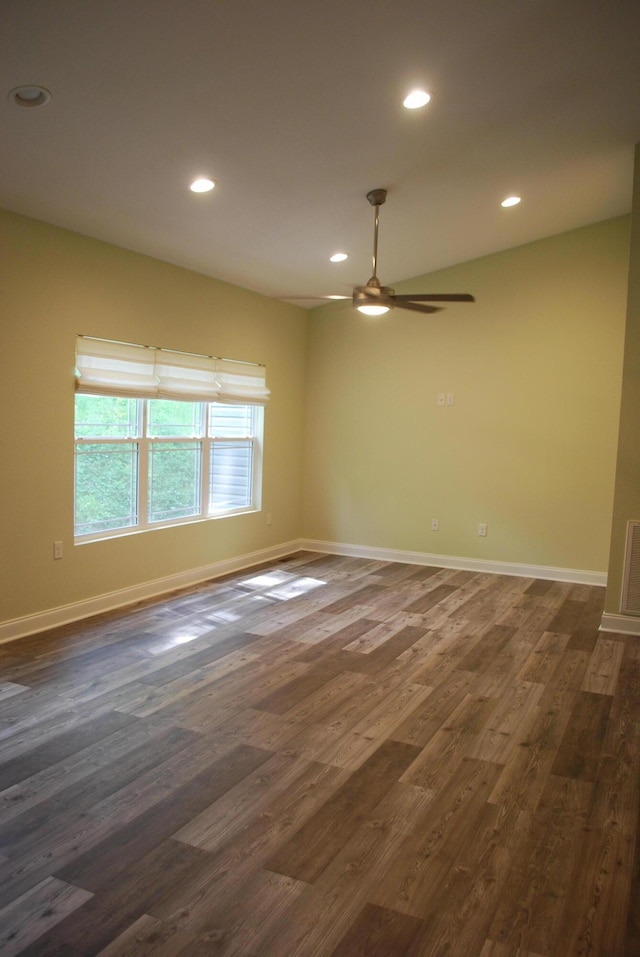 spare room with ceiling fan and dark hardwood / wood-style flooring