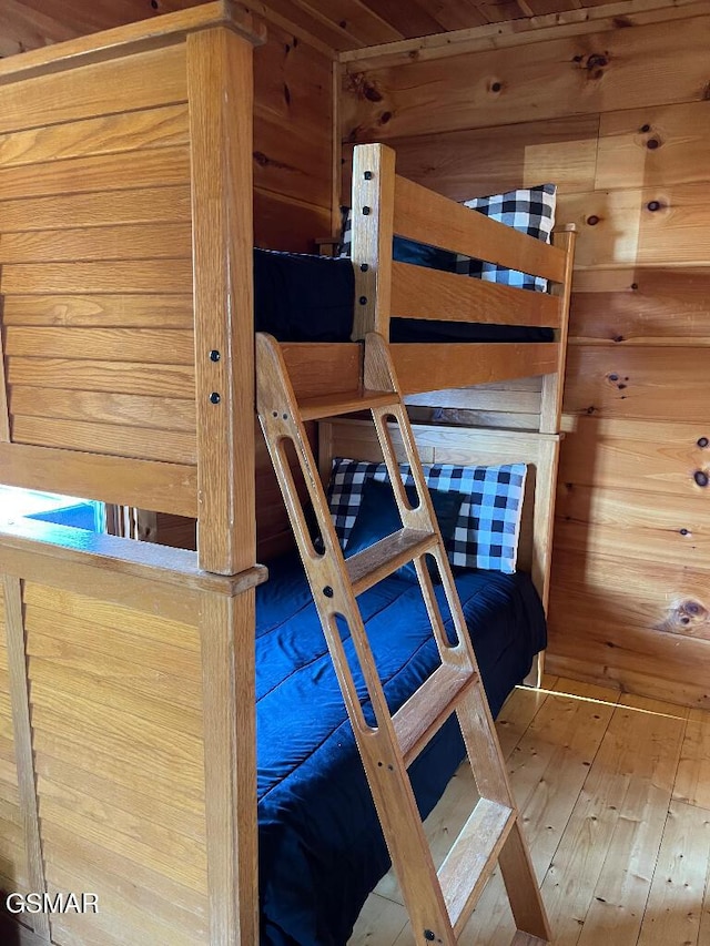 unfurnished bedroom featuring wooden walls